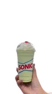 Key Lime Pie Shake from the sonic secret menu, topped with whipped cream and cherry, in a Sonic cup held by hand